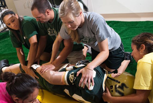 USF athletic trainers tending to an athlete
