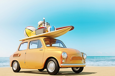 yellow compact car at the beach with beach gear on top of the roof
