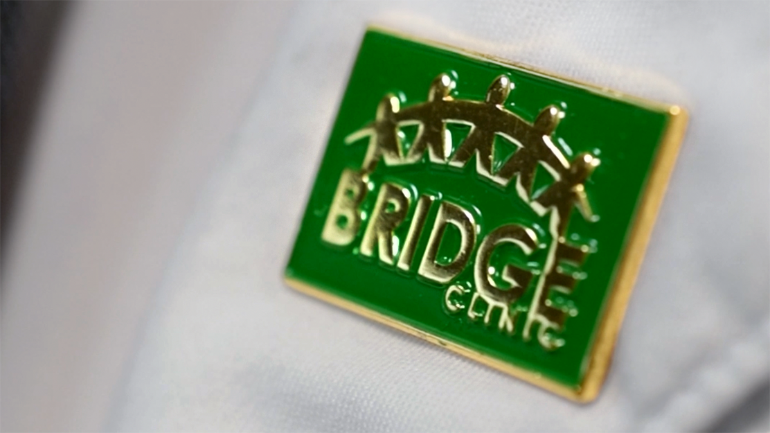 USF Health Bridge Clinic logo on a pin