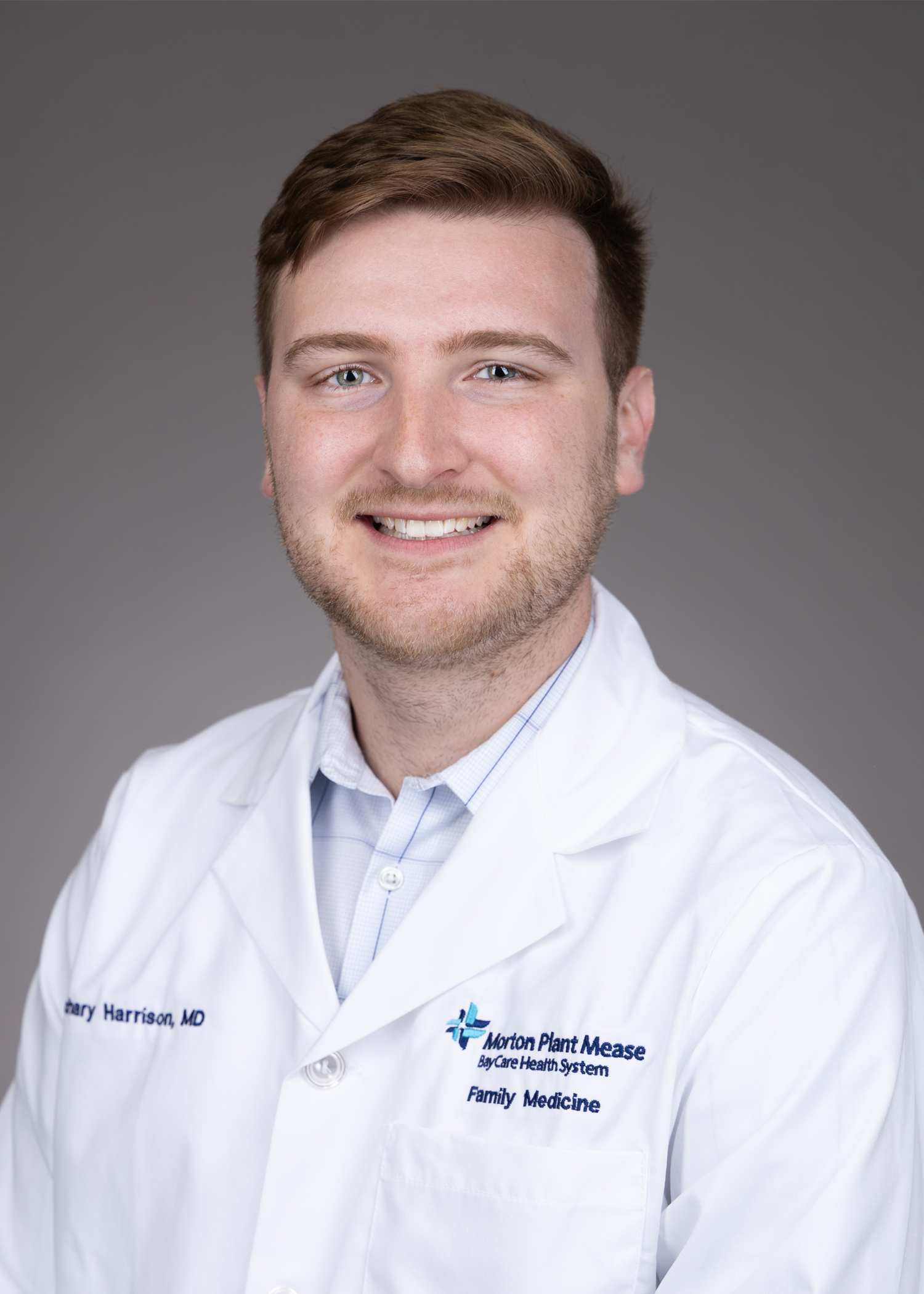 Zachary Harrison with USF Health Family Medicine Residency in a white lab coat