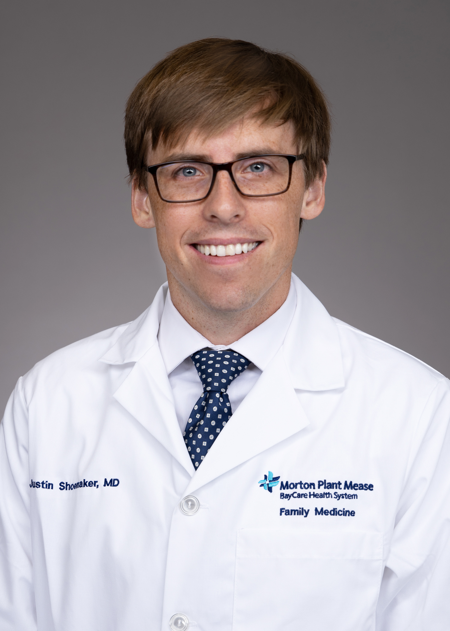 Justin Shoemaker with USF Health Family Medicine Residency in a white lab coat