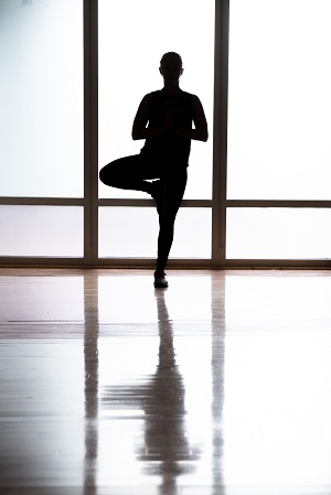 Silhouette of student doing yoga tree pose