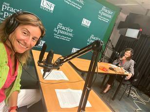 Two individuals recording a podcast in the USF College of Public Health Activist Lab studio, wearing headphones and speaking into microphones, with a USF Health backdrop in the background.