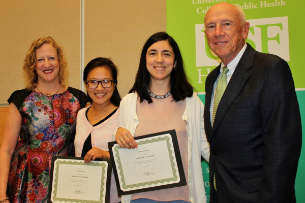Dr. Donna Petersen and Dr. Samuel P Bell standing with Sam Bell Scholarship awardees