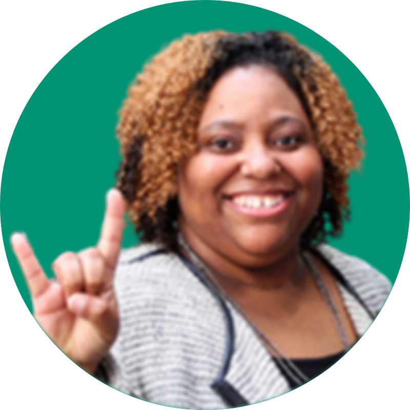 An image of Candace Webb holding up the "Go Bulls!" hand symbol in front of a green backdrop.