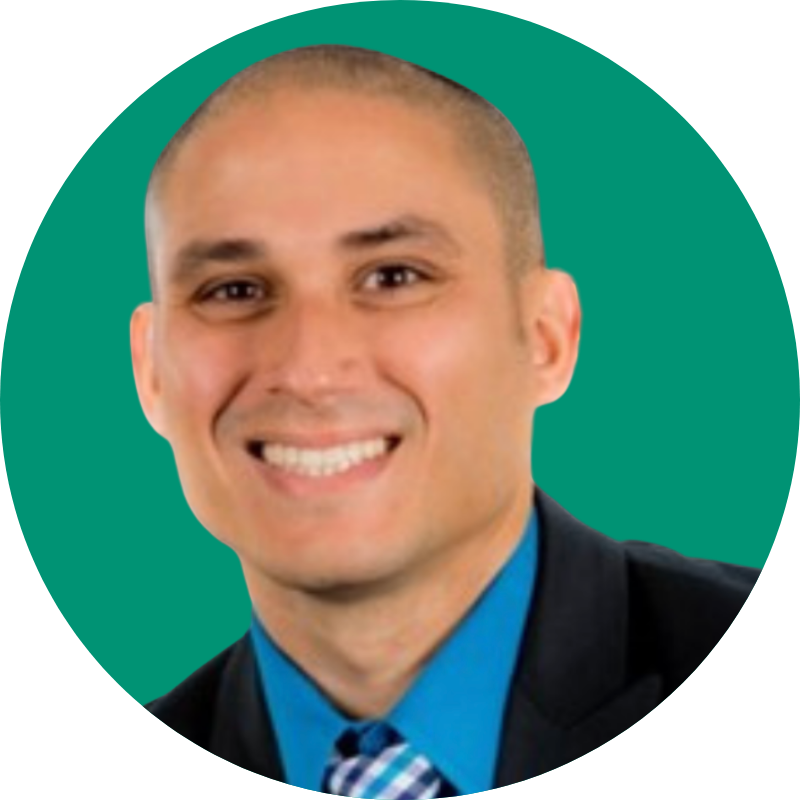 Headshot of Dr. Jason Garcia smiling in front of a green backdrop