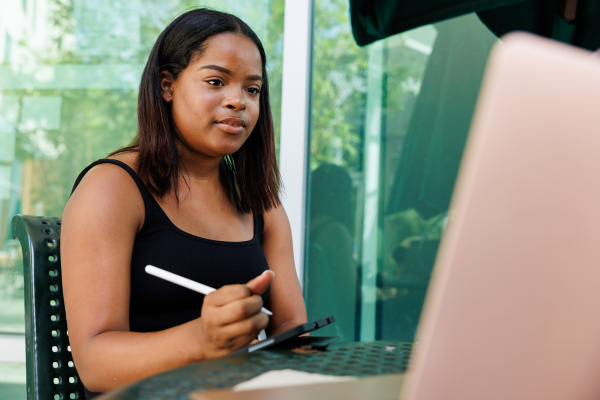 A student studying outside on her laptop
