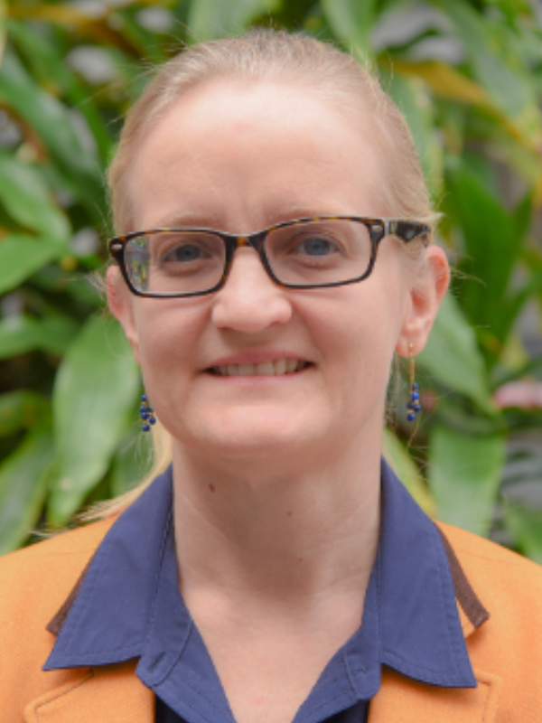 A headshot of Dr. Amy Stuart smiling in an outdoor setting