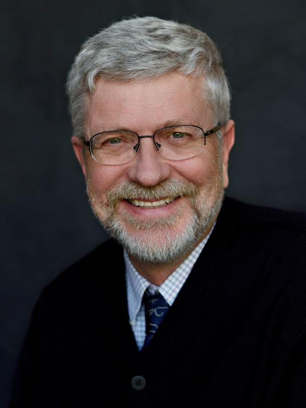 A headshot of Dr. Sten Vermund smiling in front of a dark grey backdrop
