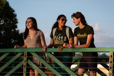 Three students standing on campus together