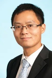 A headshot of Dr. Nanhua Zhang in front of a light blue backdrop.