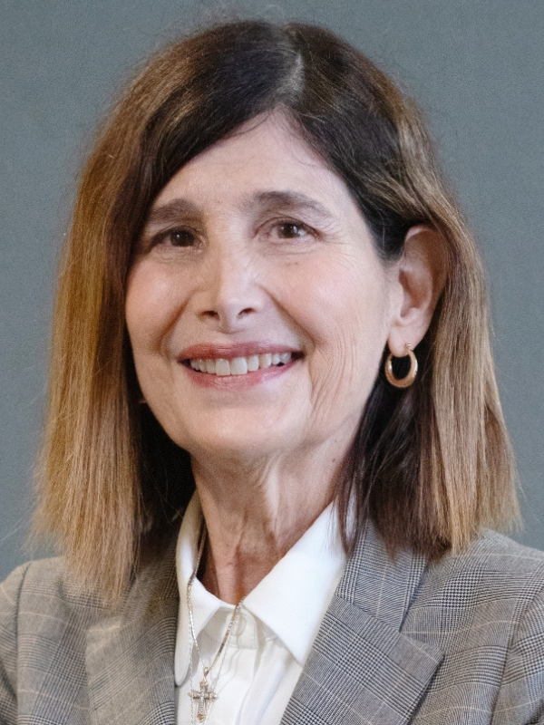 A headshot of Dr. Karen Liller posed in front of a grey background