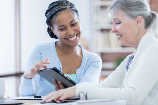 A public health professional talking to an elderly woman