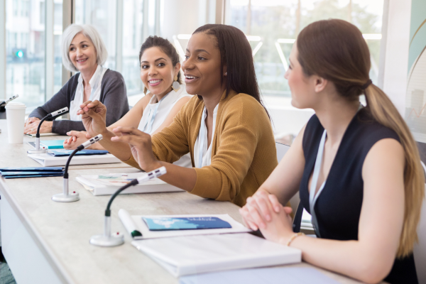 A group of people sitting at a conference table