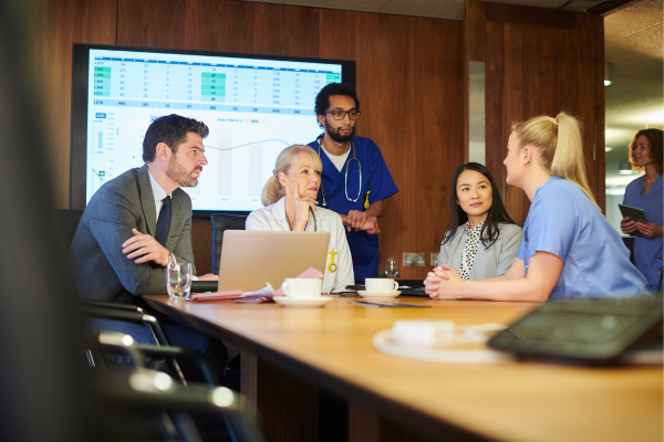 A group of people sitting around a conference table