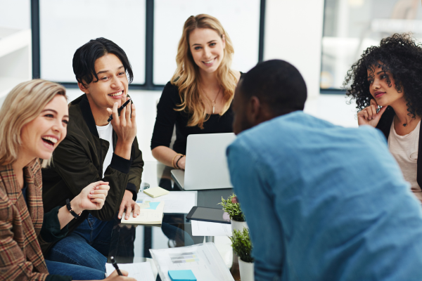 A group of employees talking with each other at a table.