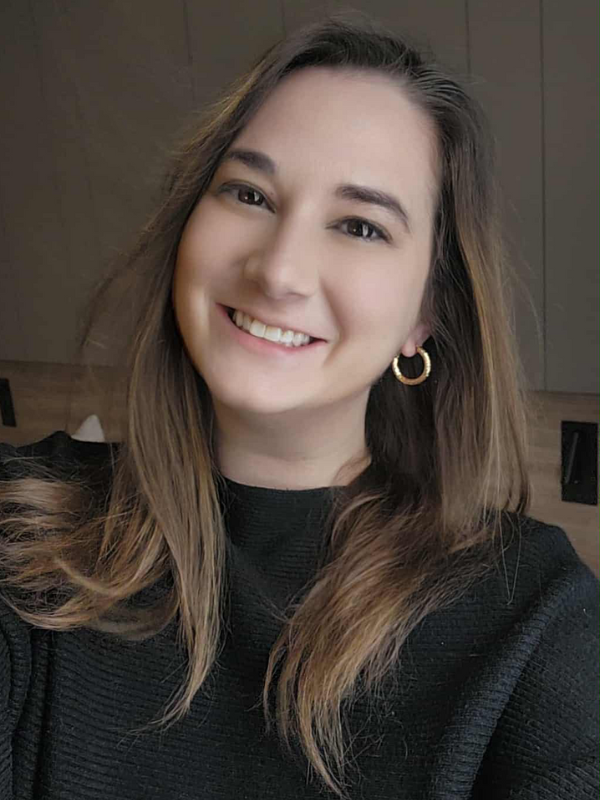Headshot of Danielle Secker in front of a brown backdrop