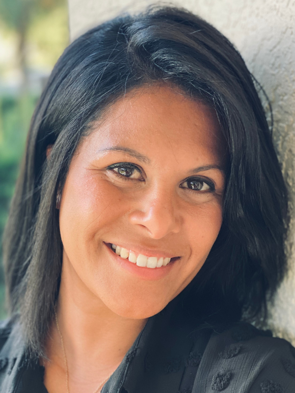 Headshot of Silvia Moreno in front of greenery