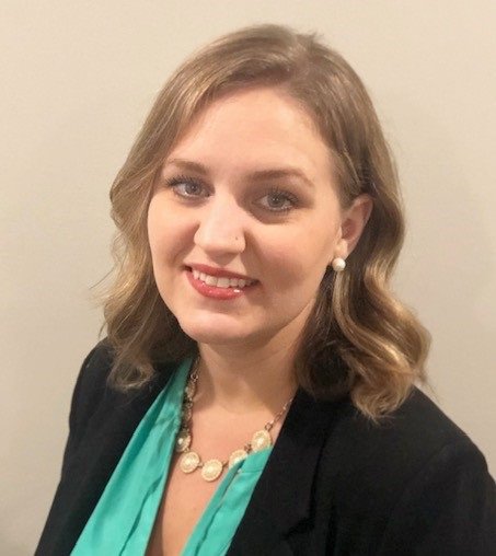 Headshot of Dr. Amanda Elmore in front of a beige backdrop.