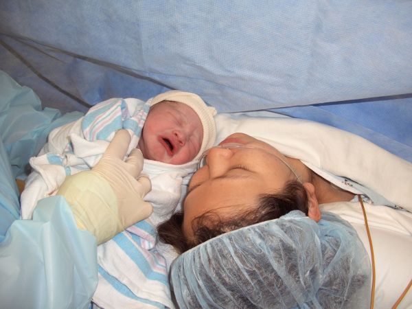 A mother and her baby lying down together after a C-Section