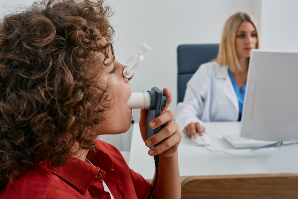 A doctor conducting a spirometry test on a patient