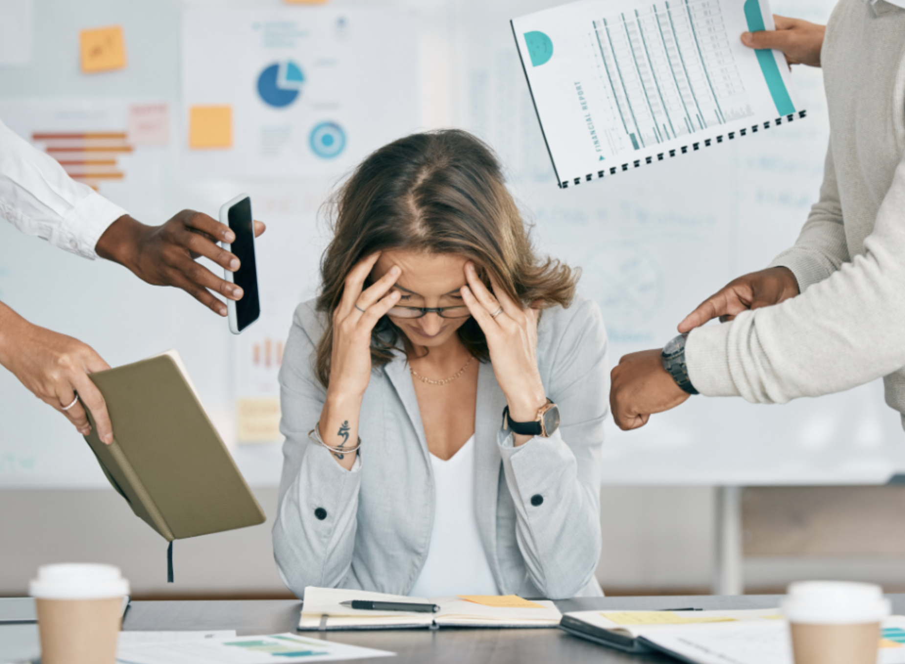 A woman appearing stressed out as multiple people hand her documents and a phone