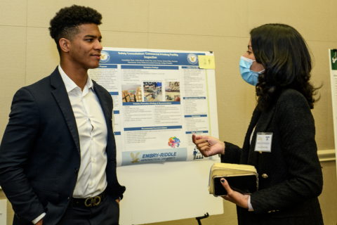 A student presenting their research poster during the Southeast Regional Research Symposium