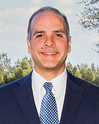 Headshot of Dr. Luis Pieretti smiling in an outdoor setting.