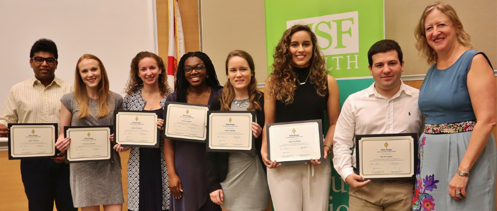 Dr. Donna Petersen standing with student inductees to the Delta Omega Honorary Society in Public Health.