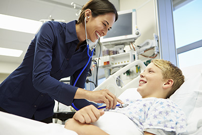 hospital female doctor at bedside with boy