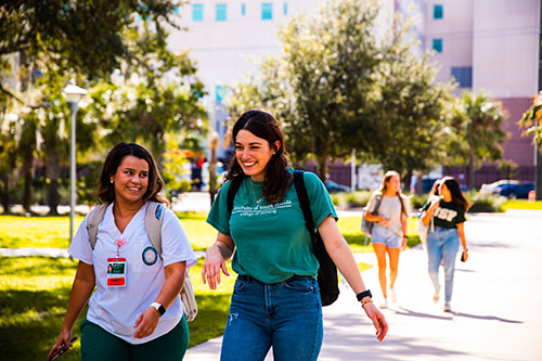 Two female nursing students walking to class
