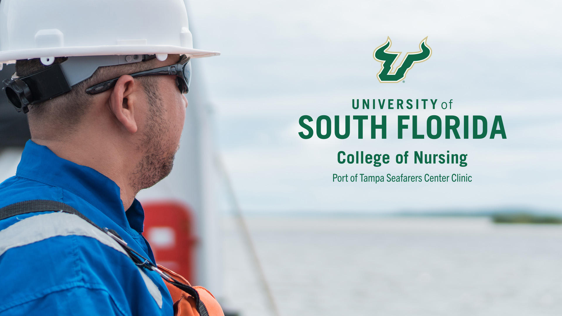 man standing in front of the ocean with hard hat