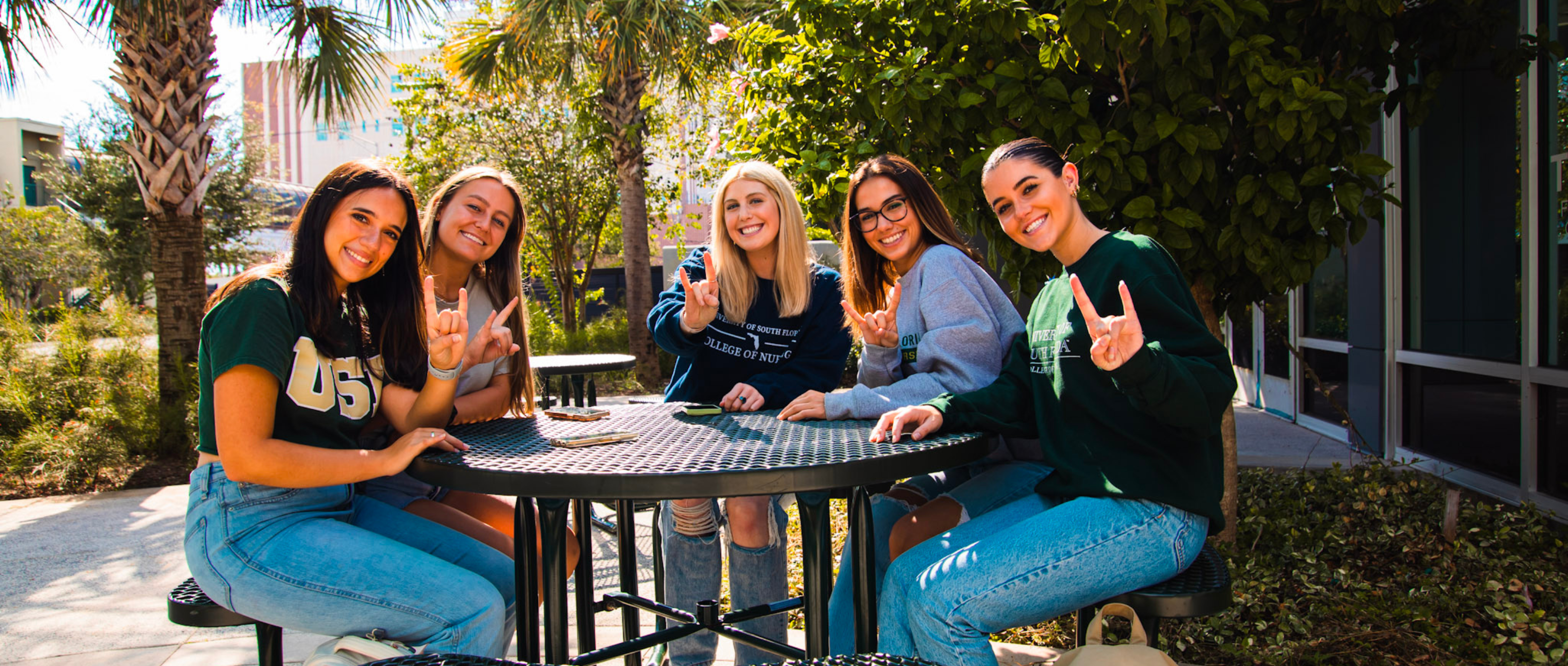 Nursing students doing the "Go Bulls" sign
