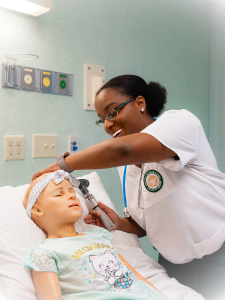 A student nurse doing an ear examination