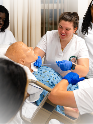 nursing students intubating manikin 