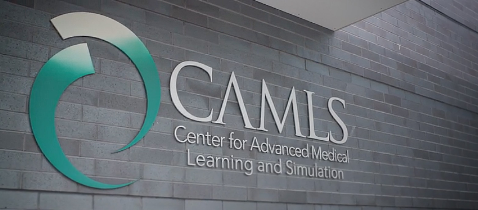 CAMLS building sign on brick wall.