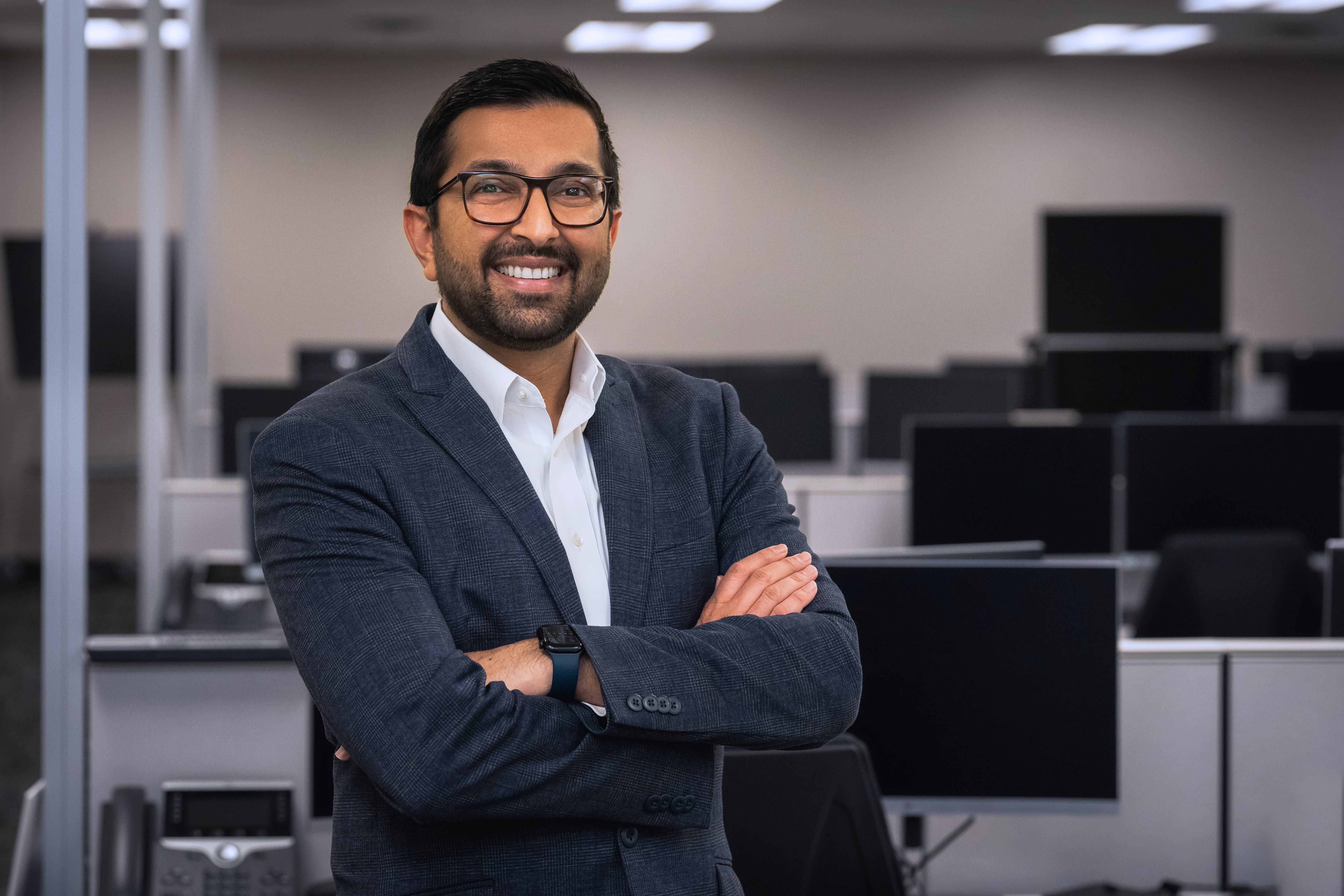 Dr. Nishit Patel of USF Health Dermatology posing with his arms crossed