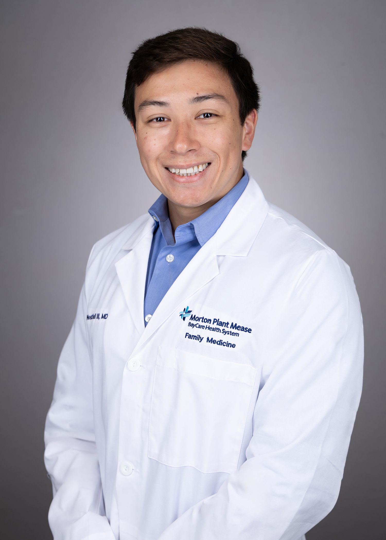 Ruchard Westfall smiling wearing a medical white coat