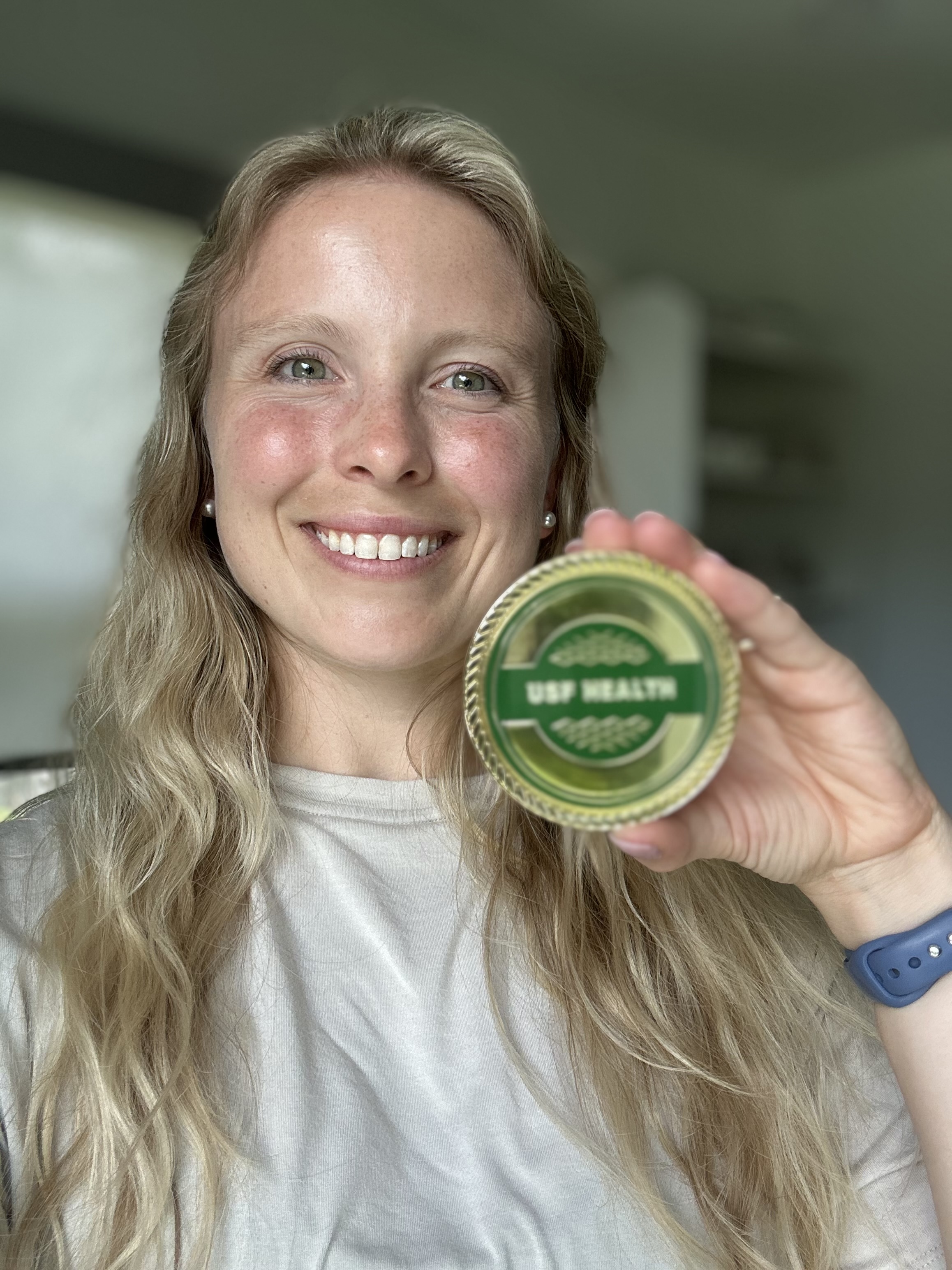 Mason Pearce holding a culture coin