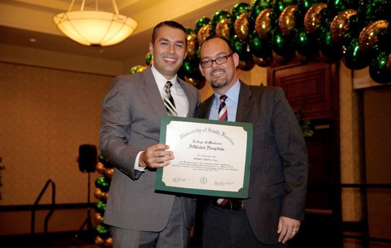 Dr. Pedro Troya surprised by Outstanding Service Certificate presented by Alejandro Ramirez, MD