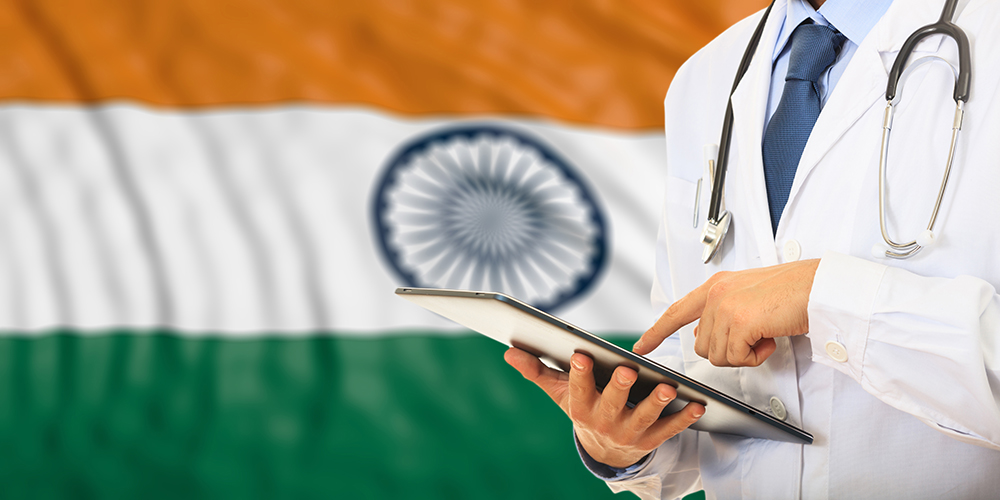 Doctor using a tablet with Indian flag as background
