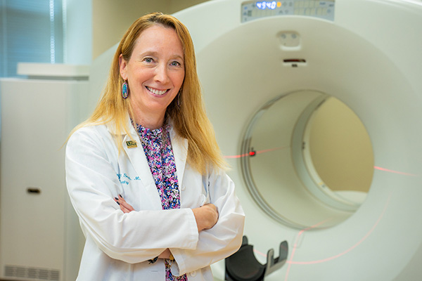 Dr. Smith standing in front of MRI medical machine