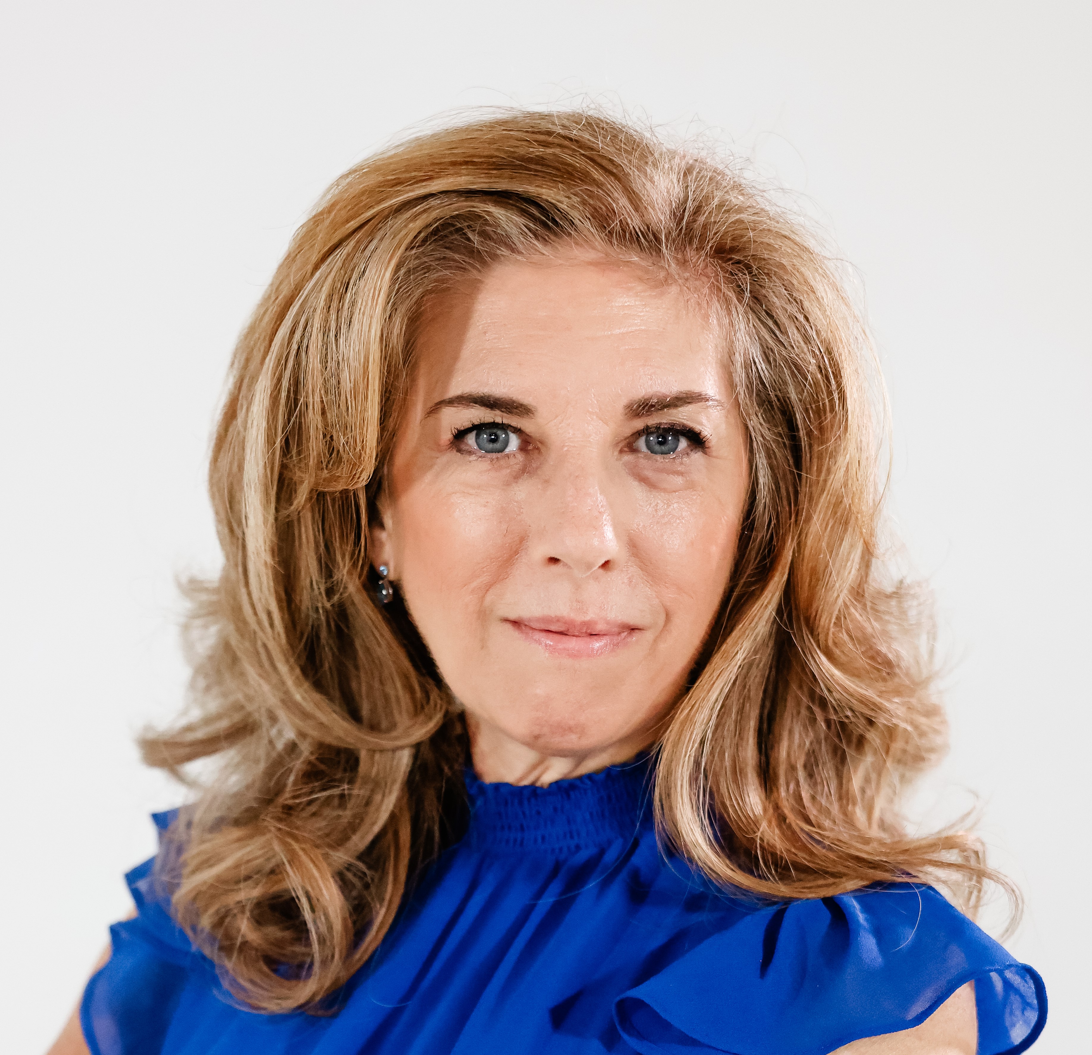 Dr. Ottomanelli smiling wearing a blue blouse