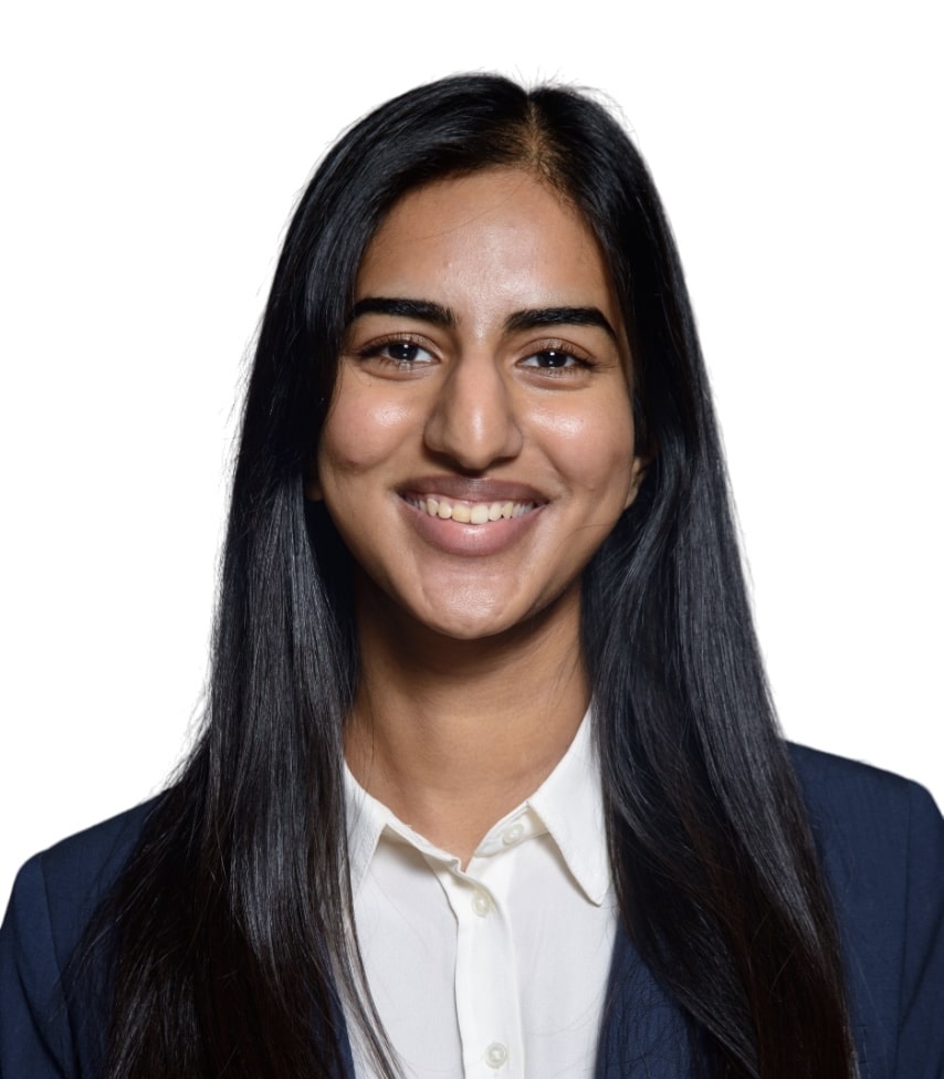 Dr. Kudapa wearing a navy blazer with button up shirt in headshot.