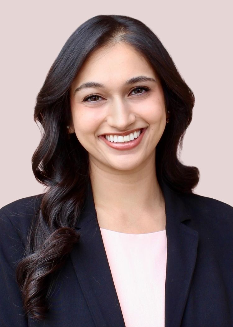 Dr. Singh wearing a navy blazer and white shirt as a headshot