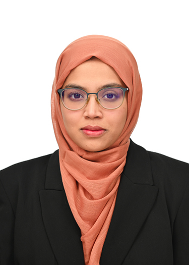 Dr. Anika in a headshot with a black blazer, glasses, and headcovering