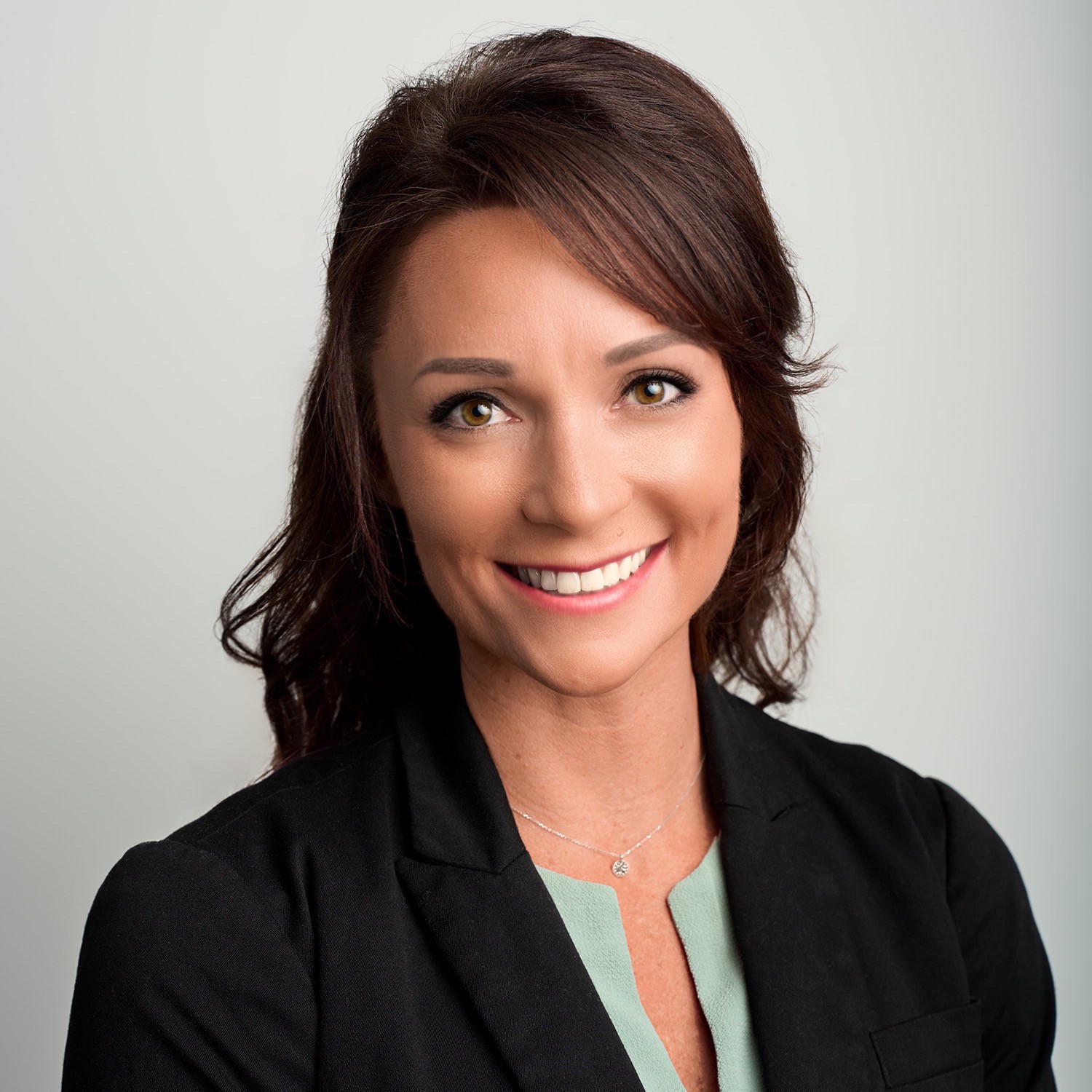 headshot of Bombly in women's suit 