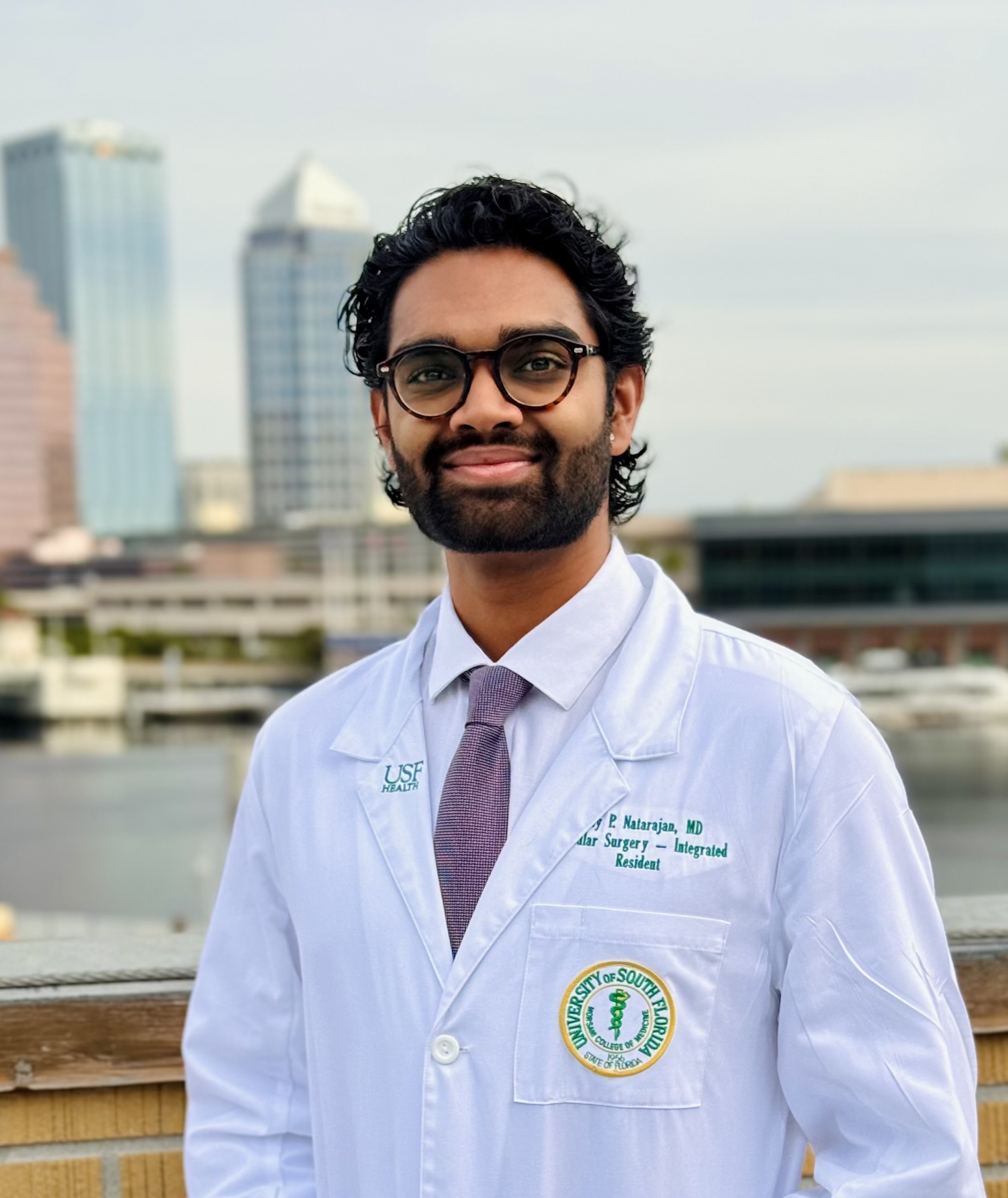 headshot of Natarajan in white coat
