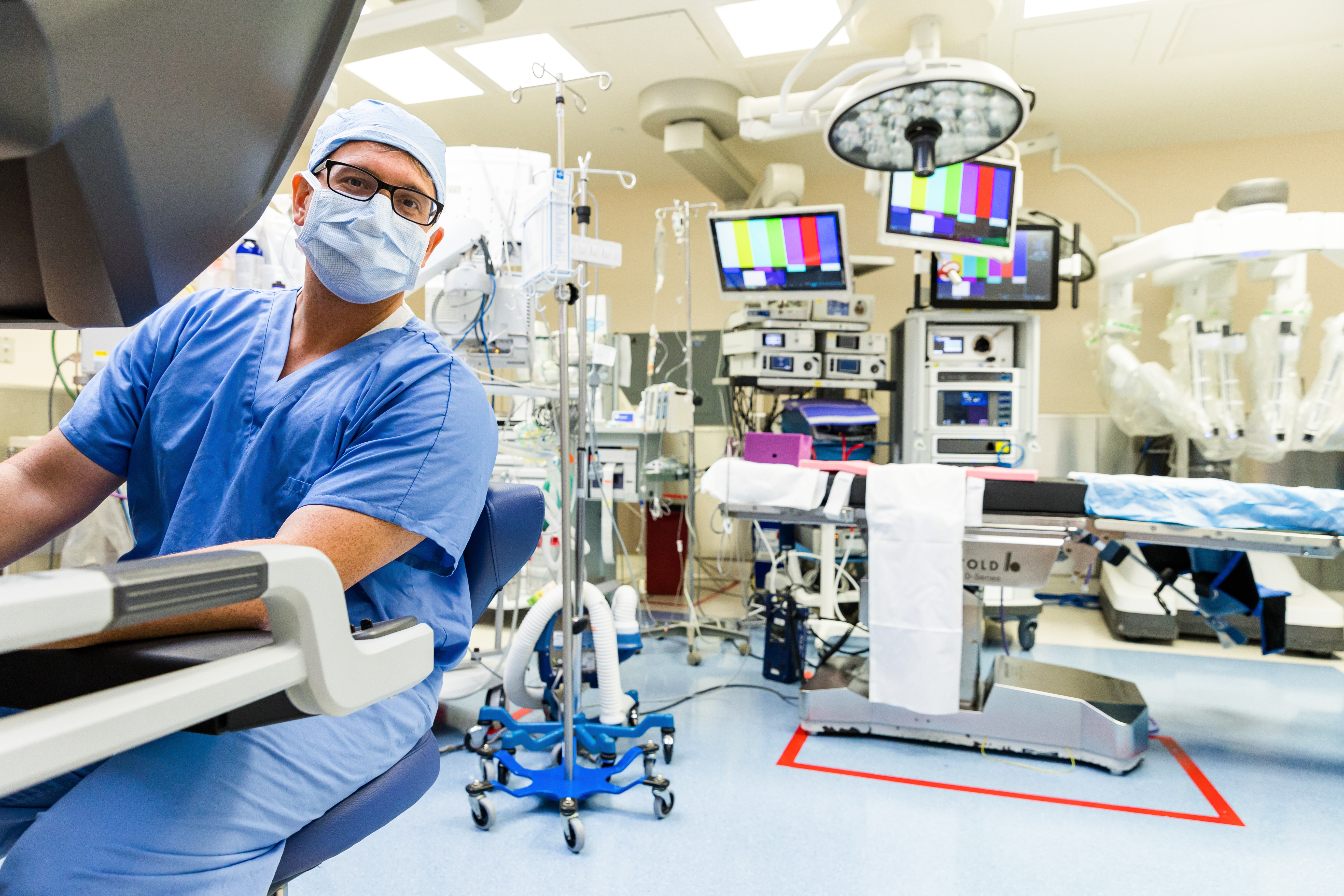 Medical personnel in blue scrubs sitting in a medical lab