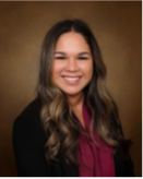 Rebeca Gonzalez Jauregui smiling in a maroon blouse and black blazer